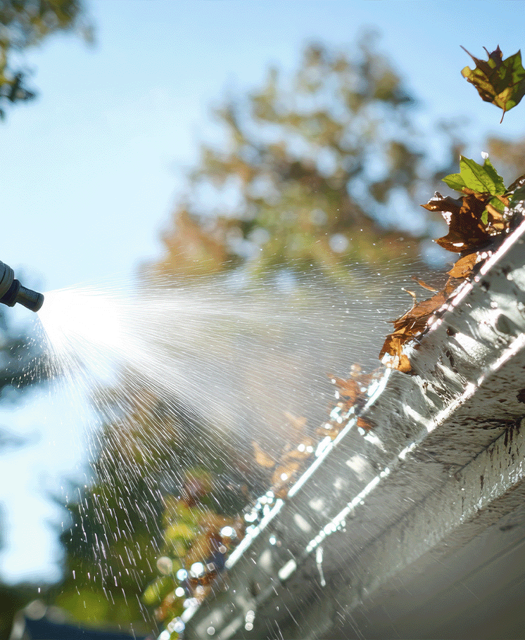 Pressure washing an eaves trough